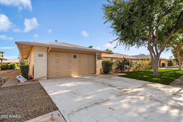 exterior space featuring a garage and a lawn