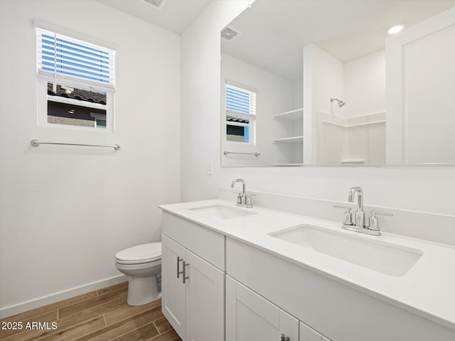 16084 W Prickly Pear Trl, Surprise, AZ 85387 - full bathroom featuring a sink, wood finished floors, a wealth of natural light, and toilet