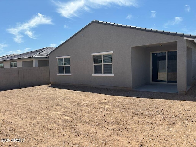16084 W Prickly Pear Trl, Surprise, AZ 85387 - back of property with fence, stucco siding, a patio area, and a tile roof
