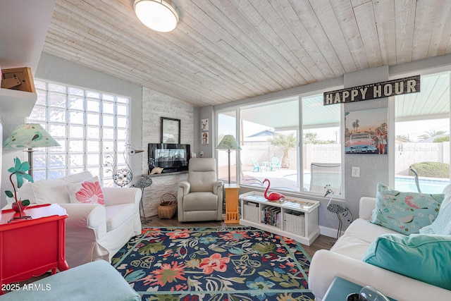 sunroom / solarium featuring lofted ceiling and wooden ceiling