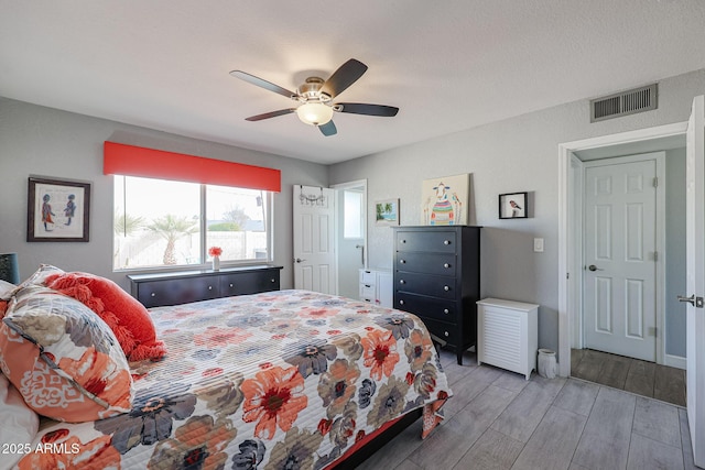 bedroom with ceiling fan and light hardwood / wood-style flooring