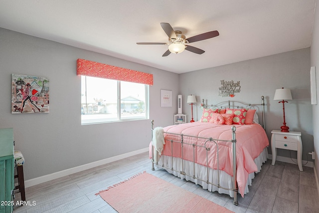 bedroom with ceiling fan and light wood-type flooring