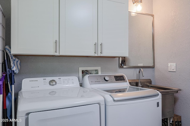 laundry area featuring cabinets and washer and clothes dryer