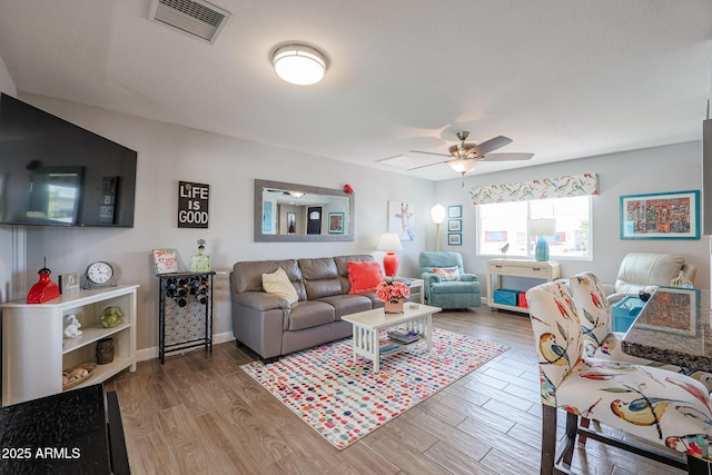 living room with hardwood / wood-style floors and ceiling fan