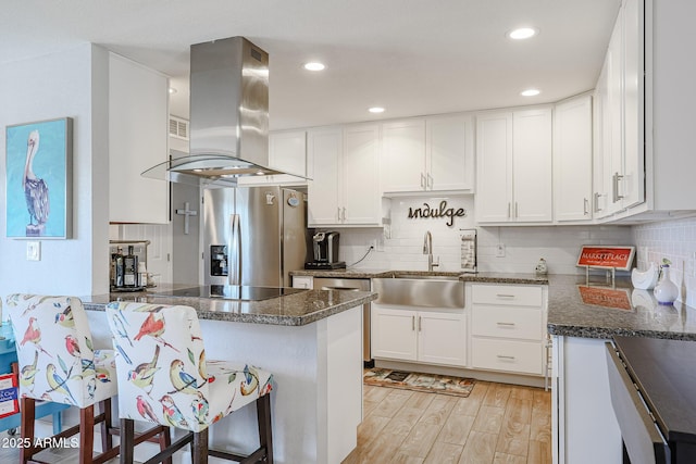 kitchen featuring sink, white cabinetry, a kitchen breakfast bar, stainless steel refrigerator with ice dispenser, and island exhaust hood