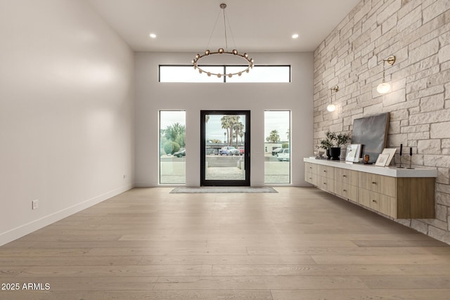 foyer with a high ceiling and light wood-type flooring