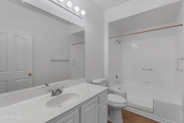 full bath featuring tub / shower combination, vanity, toilet, and wood finished floors