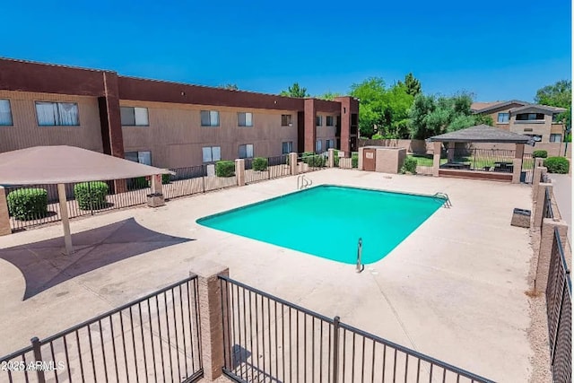community pool featuring a gazebo, a patio, and fence