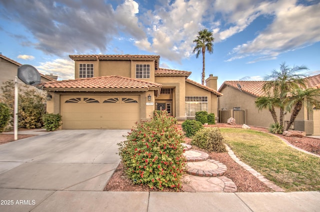 mediterranean / spanish-style home with a garage