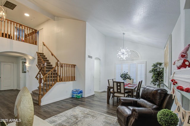 living room with beam ceiling, dark hardwood / wood-style flooring, an inviting chandelier, and high vaulted ceiling