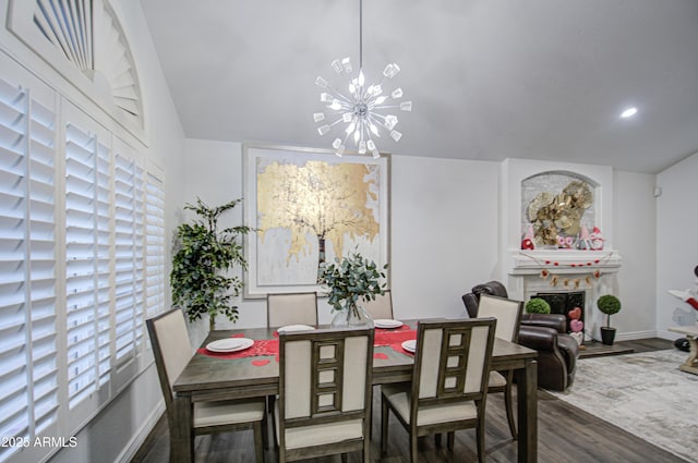 dining space with dark hardwood / wood-style floors and an inviting chandelier