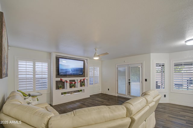 living room featuring ceiling fan, french doors, dark hardwood / wood-style floors, and a textured ceiling