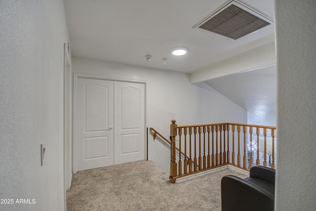 hall with vaulted ceiling and carpet flooring