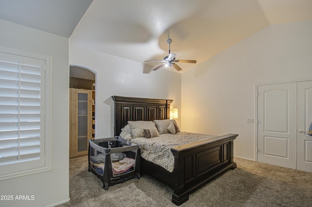 bedroom featuring ceiling fan, vaulted ceiling, and light carpet