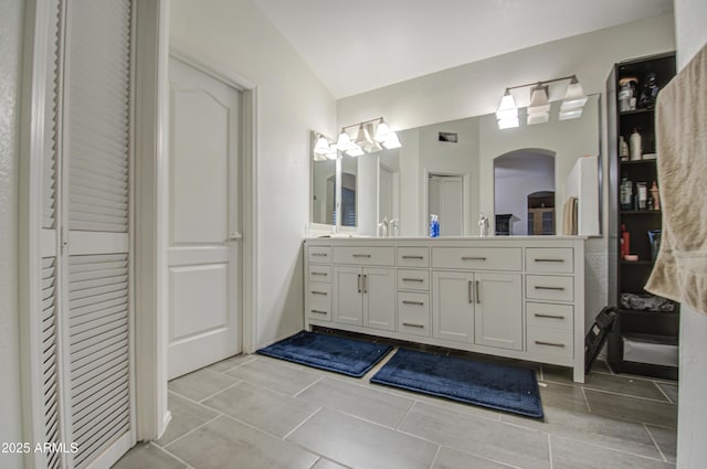 bathroom with tile patterned flooring and vanity