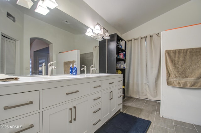 bathroom featuring tile patterned flooring, a shower with curtain, and vanity