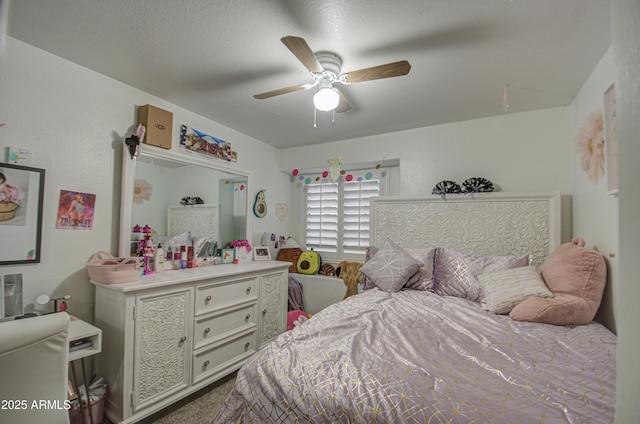 bedroom with ceiling fan and a textured ceiling