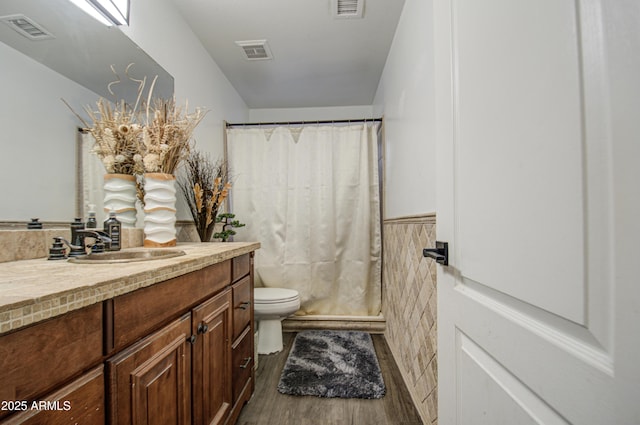 bathroom featuring toilet, vanity, a shower with shower curtain, and hardwood / wood-style floors