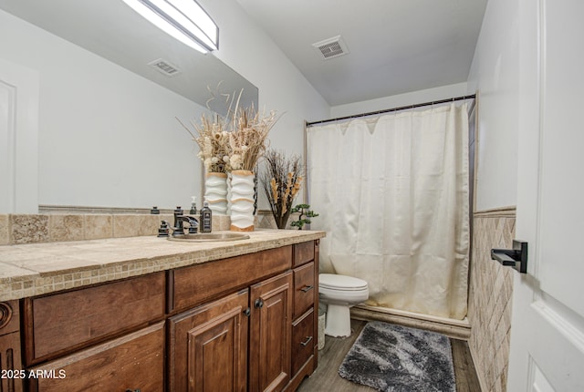 bathroom with toilet, vanity, a shower with curtain, and hardwood / wood-style flooring