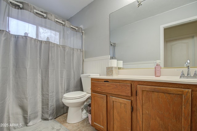 bathroom featuring toilet, tile patterned floors, and vanity