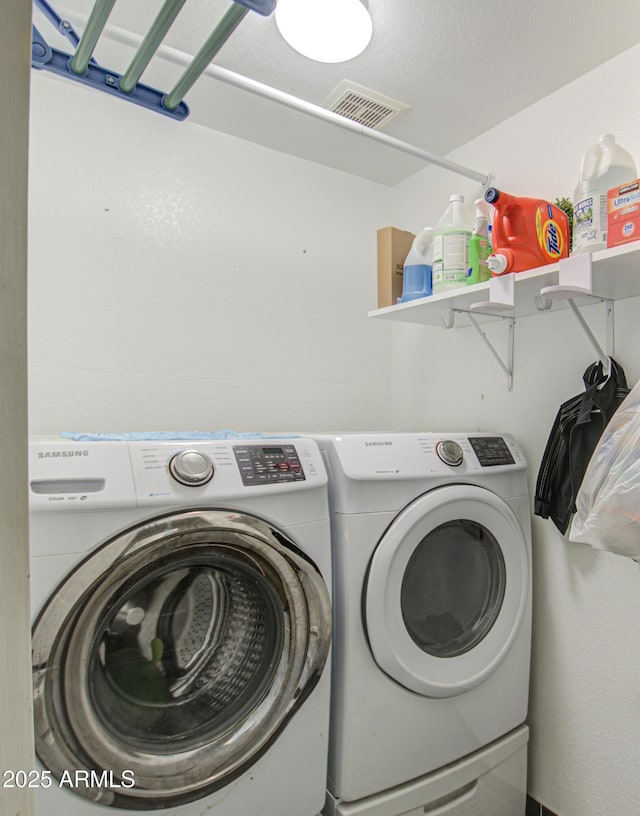 washroom featuring washing machine and dryer