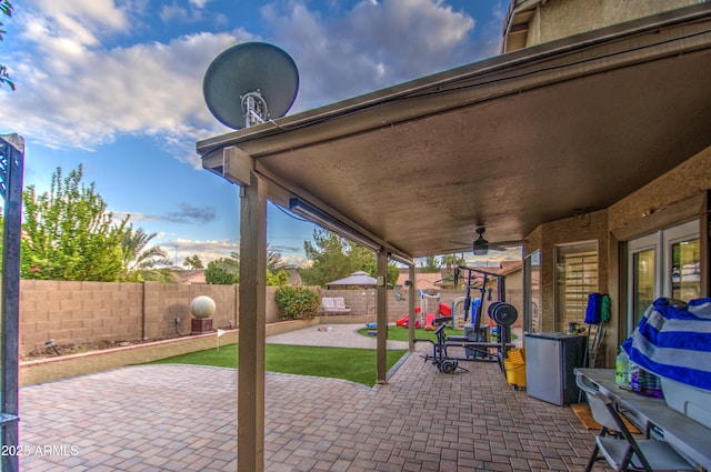 view of patio featuring ceiling fan and a playground