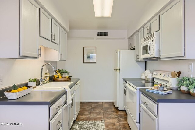 kitchen featuring white appliances and sink