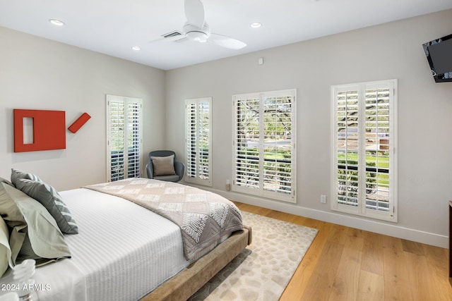 bedroom with ceiling fan and light hardwood / wood-style floors