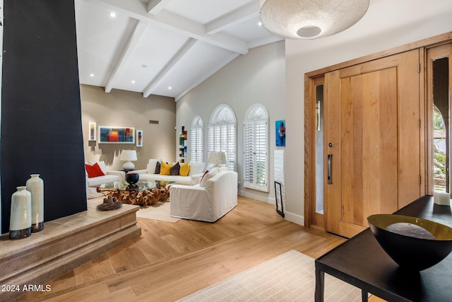 living room with hardwood / wood-style floors and lofted ceiling with beams