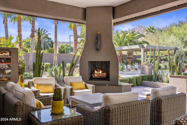 view of patio with an outdoor living space with a fireplace