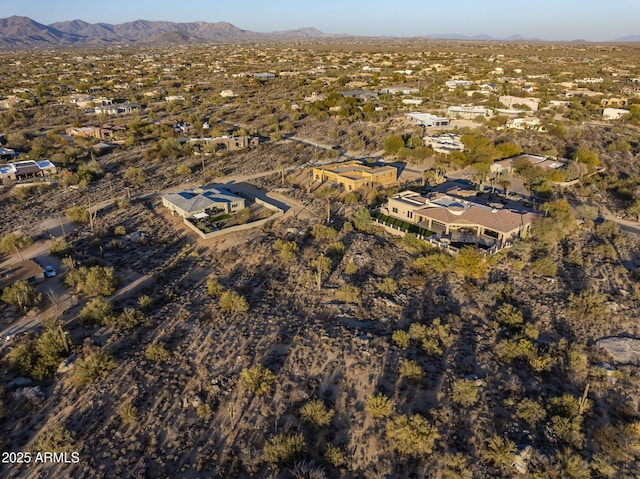 birds eye view of property with a mountain view