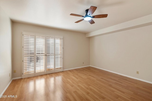 empty room featuring ceiling fan and light hardwood / wood-style flooring