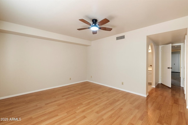 empty room with ceiling fan and light hardwood / wood-style flooring