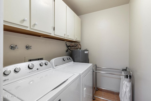 clothes washing area featuring water heater, cabinet space, washer and clothes dryer, and light tile patterned flooring