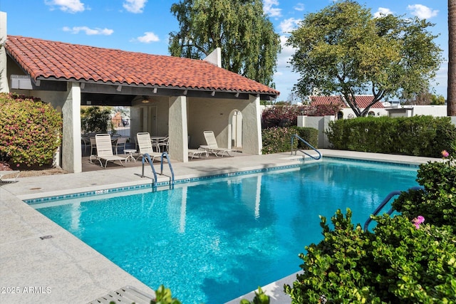 pool featuring a patio and fence