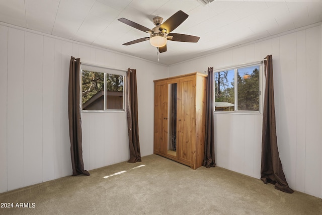 unfurnished bedroom with light colored carpet and ceiling fan