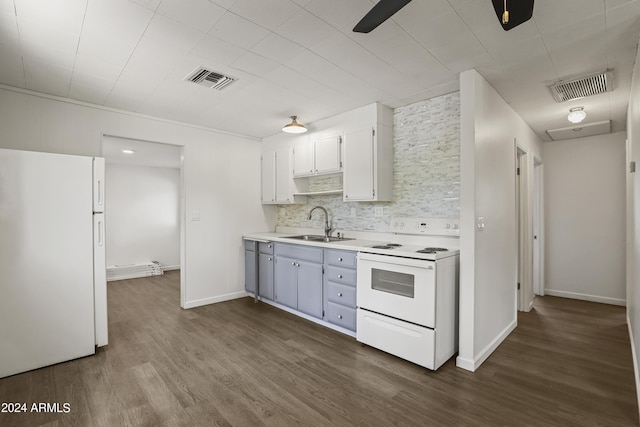 kitchen featuring decorative backsplash, white appliances, dark wood-type flooring, sink, and white cabinetry