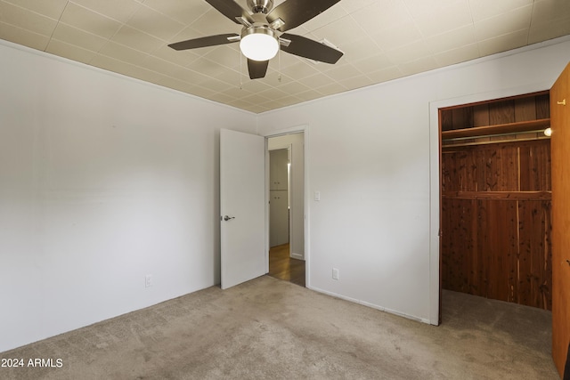 unfurnished bedroom with light carpet, a closet, and ceiling fan