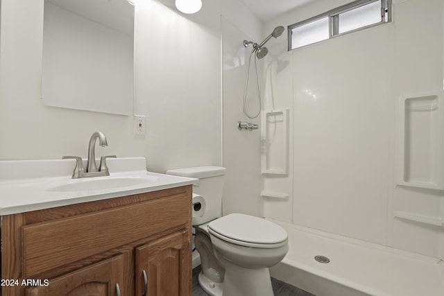 bathroom featuring walk in shower, vanity, and toilet