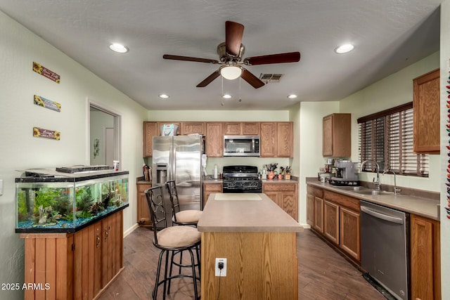 40264 W Lococo St, Maricopa, AZ 85138 - kitchen with a ceiling fan, appliances with stainless steel finishes, a center island, dark wood finished floors, and a sink