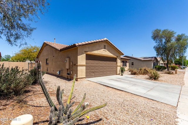 40264 W Lococo St, Maricopa, AZ 85138 - view of front of home featuring fence, stucco siding, a tiled roof, an attached garage, and driveway