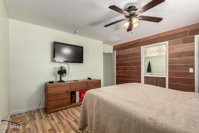 40264 W Lococo St, Maricopa, AZ 85138 - bedroom with visible vents, wood walls, baseboards, ceiling fan, and light wood-style flooring