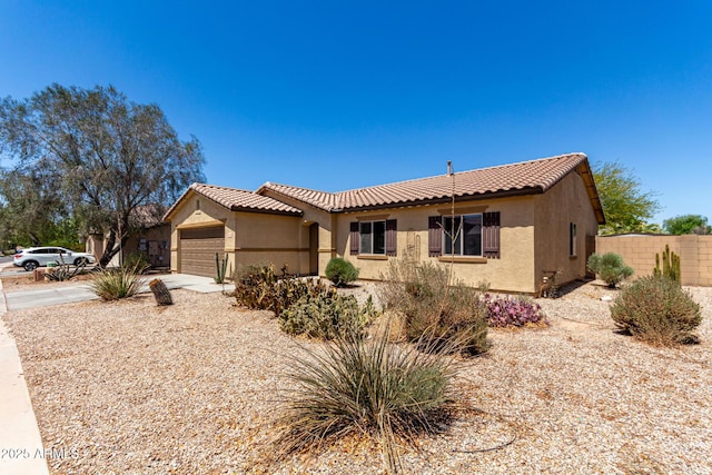 40264 W Lococo St, Maricopa, AZ 85138 - view of front of house featuring a tiled roof, an attached garage, fence, and stucco siding