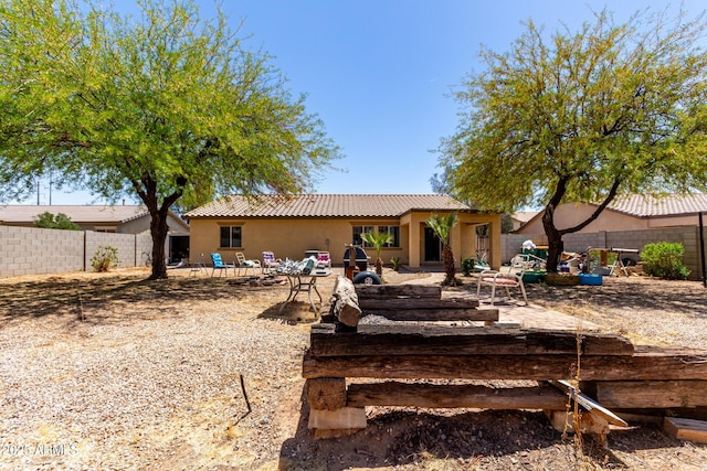 40264 W Lococo St, Maricopa, AZ 85138 - rear view of house with fence, a tiled roof, and stucco siding