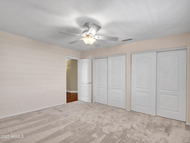 19506 N 73rd Ave, Glendale, AZ 85308 - unfurnished bedroom with multiple closets, carpet floors, baseboards, and ceiling fan