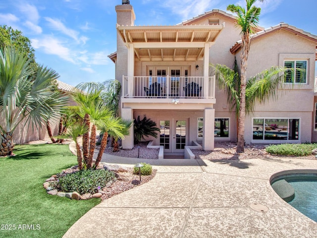 19506 N 73rd Ave, Glendale, AZ 85308 - back of property featuring french doors, a balcony, a chimney, and stucco siding