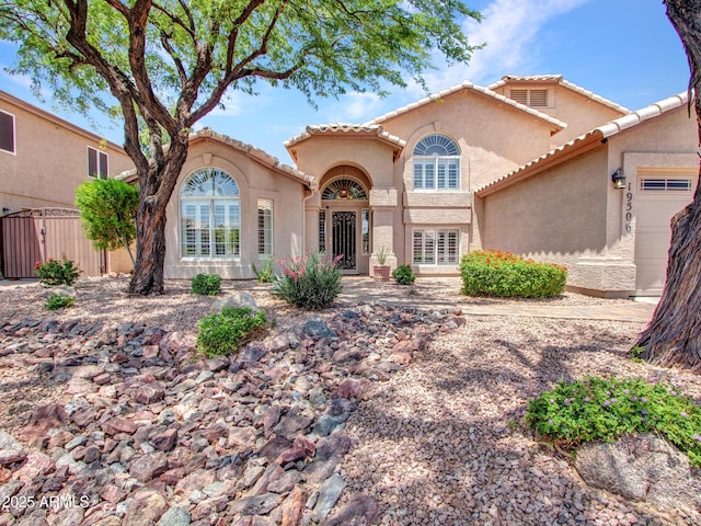 19506 N 73rd Ave, Glendale, AZ 85308 - mediterranean / spanish-style house with stucco siding, a tiled roof, and a garage