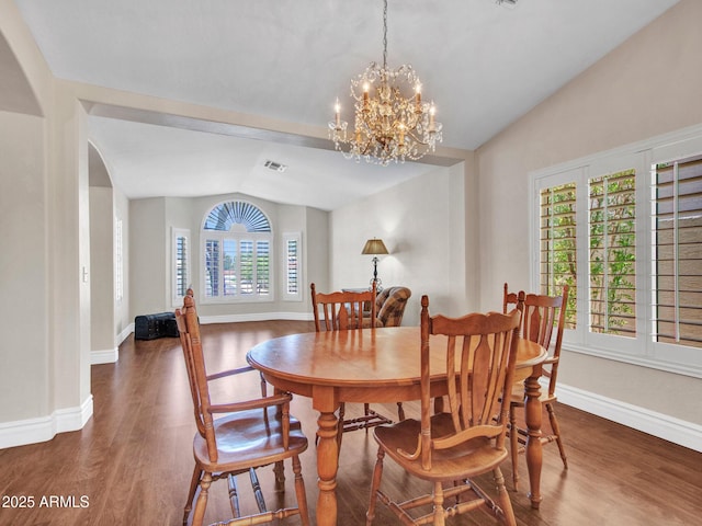 19506 N 73rd Ave, Glendale, AZ 85308 - dining area with lofted ceiling, wood finished floors, baseboards, a chandelier, and arched walkways