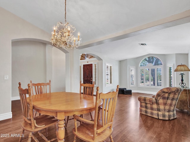 19506 N 73rd Ave, Glendale, AZ 85308 - dining room featuring arched walkways, vaulted ceiling, baseboards, wood finished floors, and a chandelier