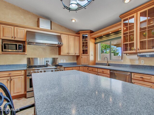 19506 N 73rd Ave, Glendale, AZ 85308 - kitchen featuring wall chimney range hood, appliances with stainless steel finishes, a sink, vaulted ceiling, and light tile patterned floors